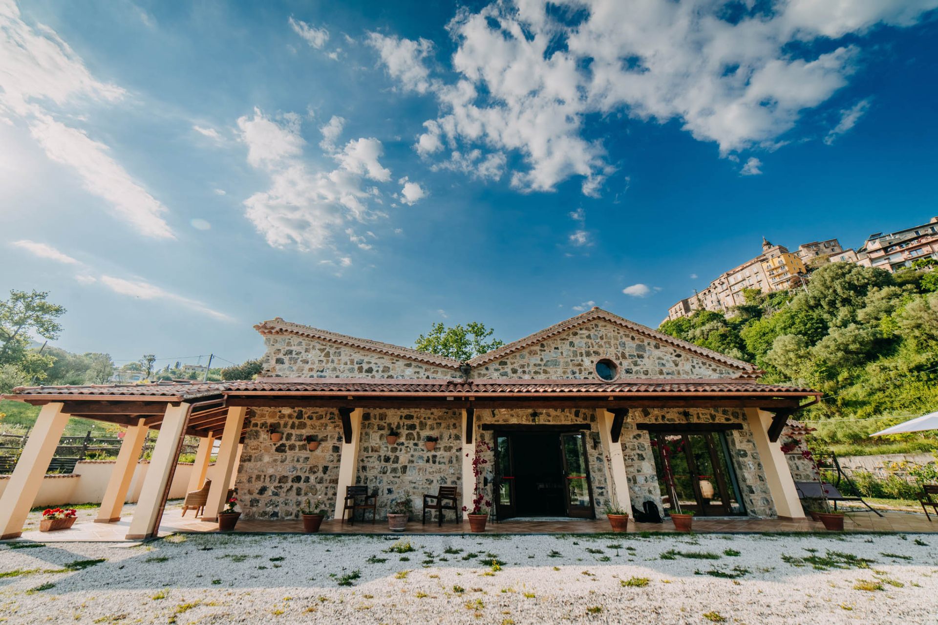 Facciata frontale in pietra con cielo azzurro e nuvole